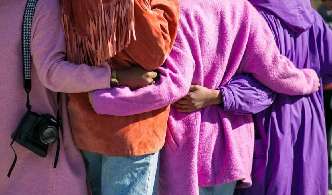 four person holding each others waist at daytime