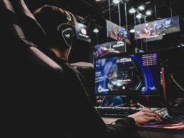 person sitting on gaming chair while playing video game
