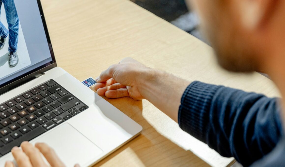 A man sitting in front of a laptop computer
