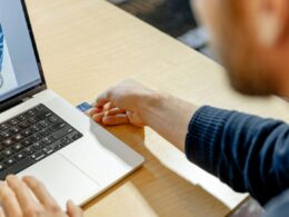 A man sitting in front of a laptop computer