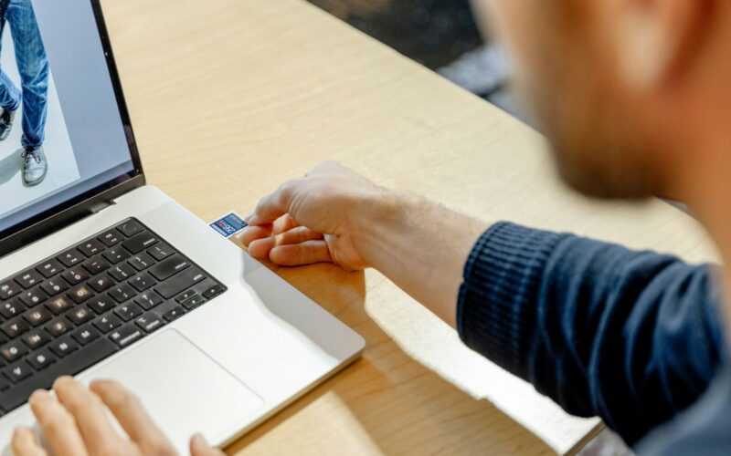 A man sitting in front of a laptop computer
