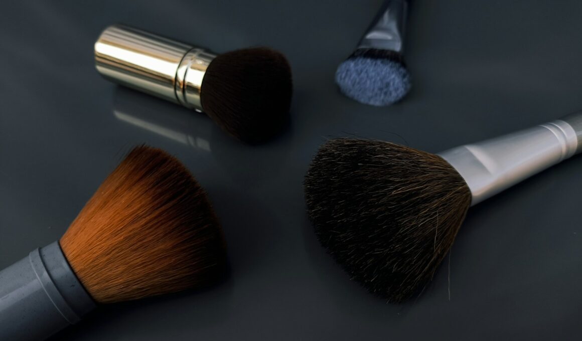 A close up of three makeup brushes on a table