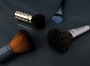 A close up of three makeup brushes on a table