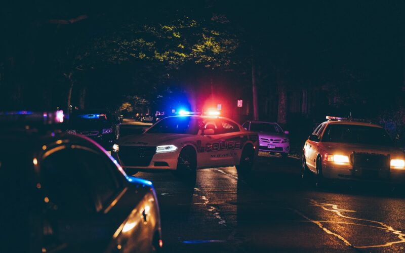 A couple of police cars parked in a parking lot