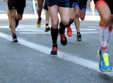 people running on gray asphalt road during daytime