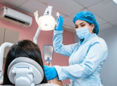 a woman getting her teeth checked by a dentist