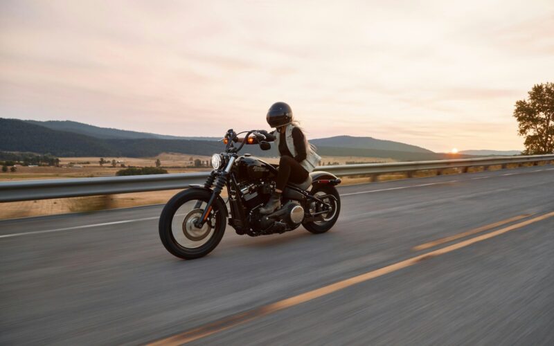 man on black cruiser motorcycle in highway