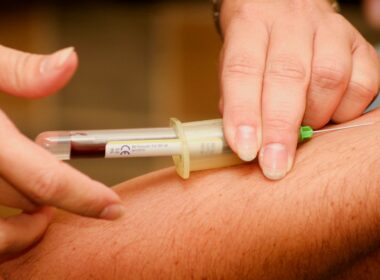 person injecting syringe