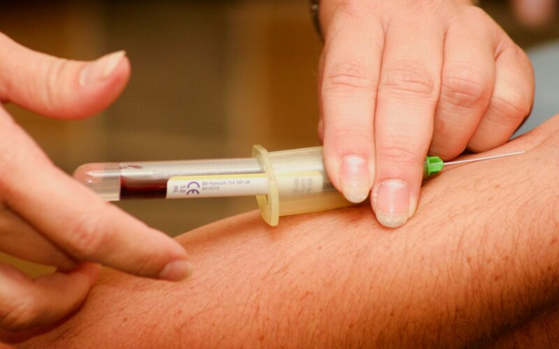 person injecting syringe
