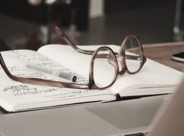 eyeglasses with gray frames on the top of notebook