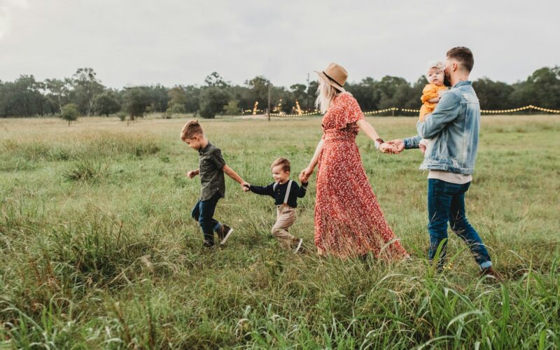 woman holding man and toddler hands during daytime