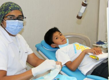a young boy getting his teeth checked by a dentist