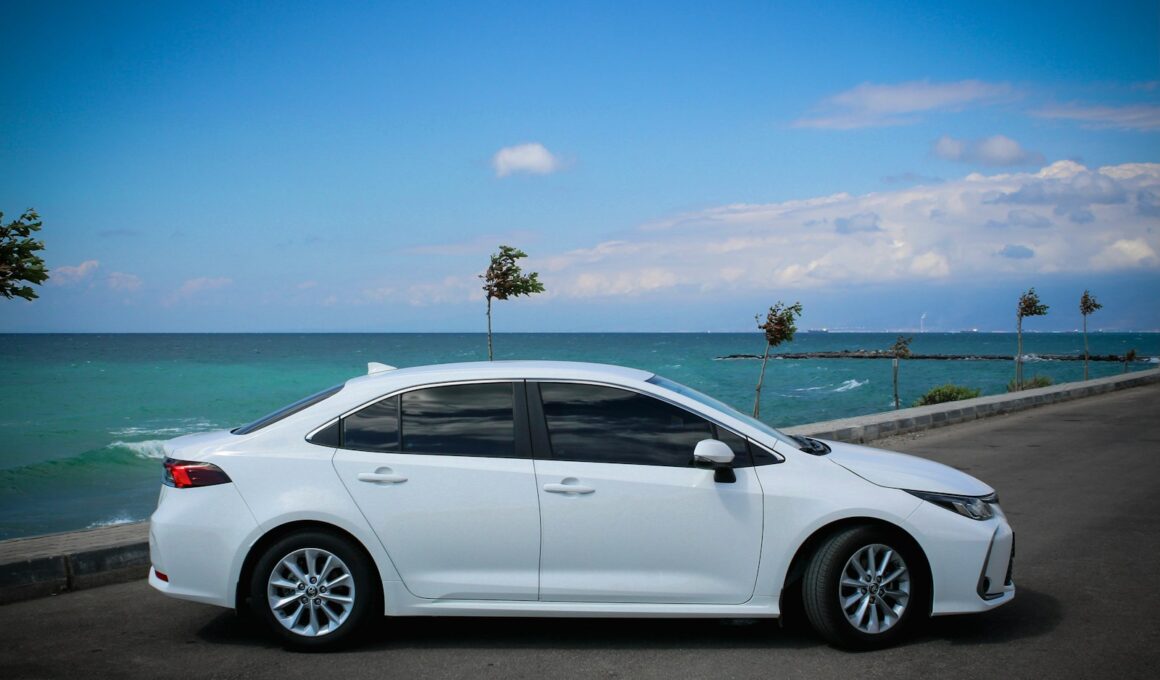 white sedan on gray asphalt road during daytime