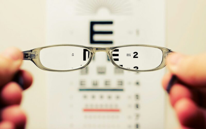 person holding eyeglasses