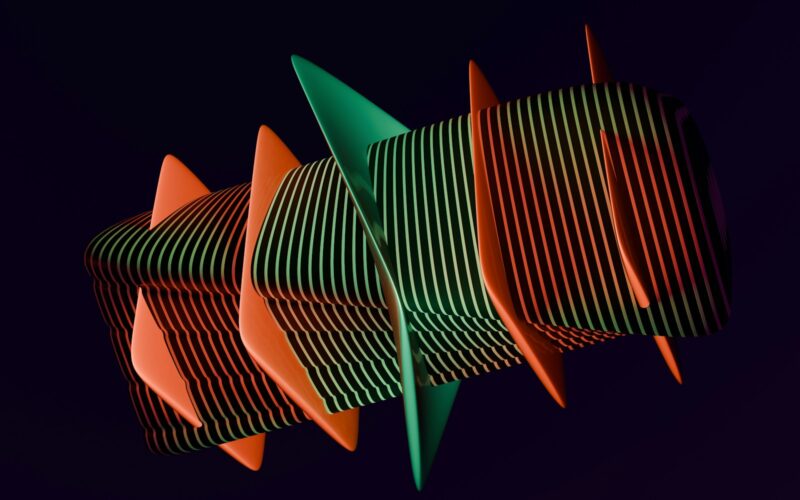 A group of orange and green objects against a black background