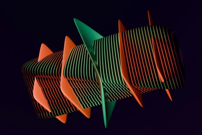 A group of orange and green objects against a black background