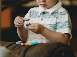 boy holding block toy