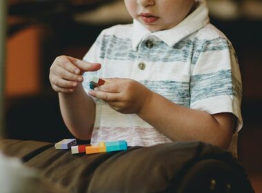 boy holding block toy