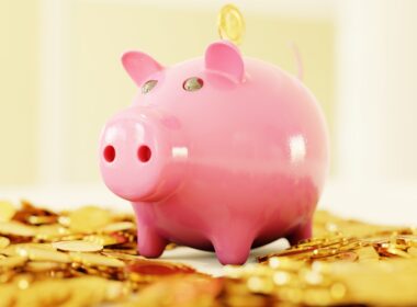 pink pig coin bank on brown wooden table