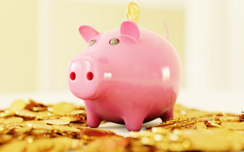 pink pig coin bank on brown wooden table