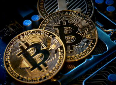 three bitcoins sitting on top of a computer motherboard