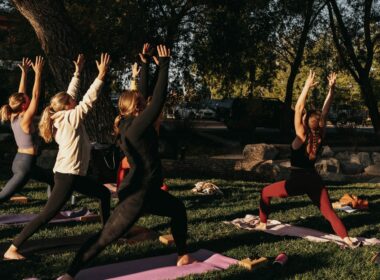 a group of people doing yoga in a park