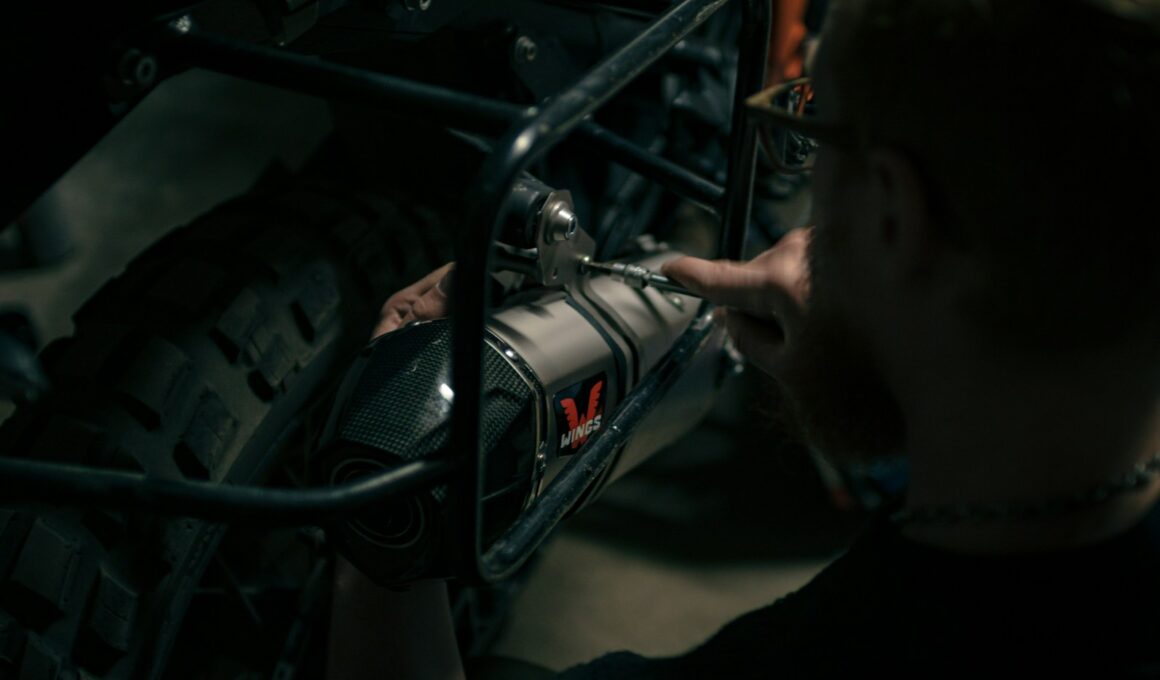 a man is working on a motorcycle engine
