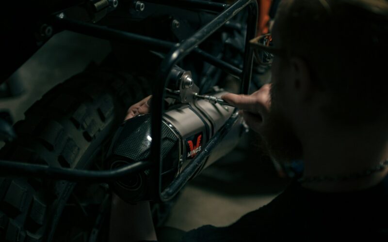 a man is working on a motorcycle engine